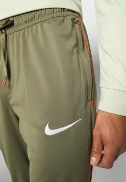 Nike Performance FC LIBERO PANT - Tracksuit Bottoms - Medium Olive/habanero Red/white -Nike Performance store 66e6bff544ab4fad9951c5656869e759