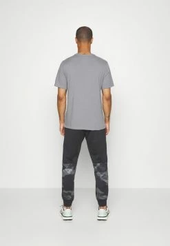 Nike Performance PANT TAPER CAMO - Tracksuit Bottoms - Black/coconut Milk -Nike Performance store 6a83877df5244b1caa8017f7111eaf76