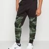 Nike Performance PANT TAPER CAMO - Tracksuit Bottoms - Velvet Brown/coconut Milk