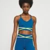 Nike Performance INDY BRA - Light Support Sports Bra - Court Blue/pink Glaze/university Gold/white