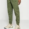 Nike Performance PANT TAPER - Tracksuit Bottoms - Rough Green/htr/alligator/(black)