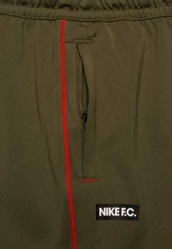 Nike Performance FC LIBERO PANT - Tracksuit Bottoms - Medium Olive/habanero Red/white -Nike Performance store b2fc788c4d924bfb8ba25e4bca143e88