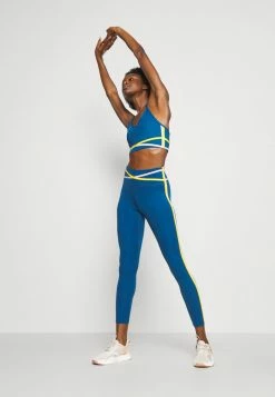 Nike Performance INDY BRA - Light Support Sports Bra - Court Blue/pink Glaze/university Gold/white -Nike Performance store cb8494bad5e44c0bbec4ee973c000906