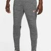 Nike Performance ACADEMY - Tracksuit Bottoms - Black/sunset Glow