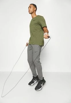 Nike Performance BURNOUT - Sports T-shirt - Rough Green/(black) -Nike Performance store f576a39544b446b7b3fac4f8d1279c81