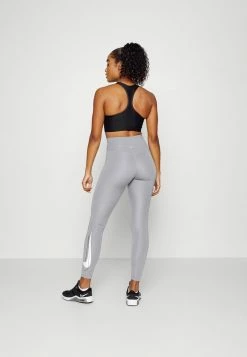 Nike Performance SEAMLESS BRA - Medium Support Sports Bra - Black/dark Smoke Grey -Nike Performance store fe183c11696940f9a9d9118395beeb9f